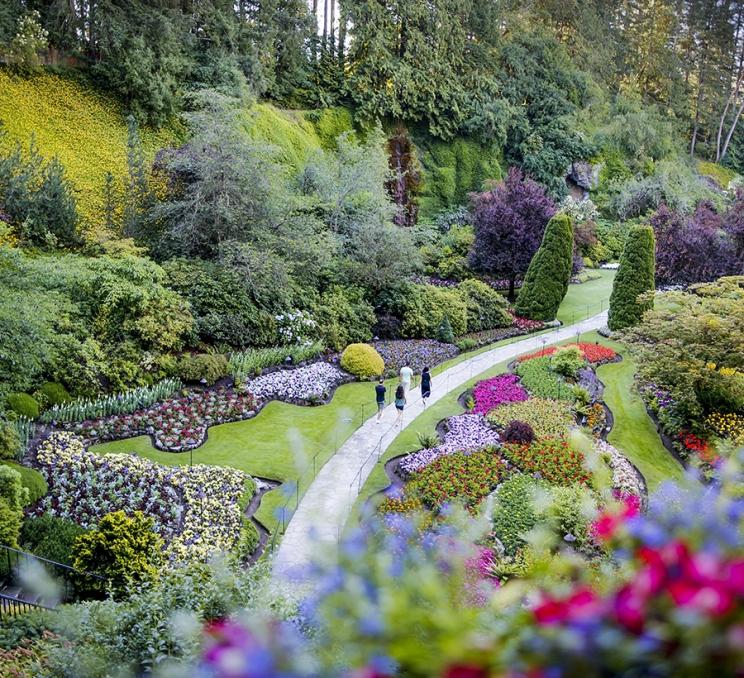 A group walks through The Butchart Gardens in Victoria, BC