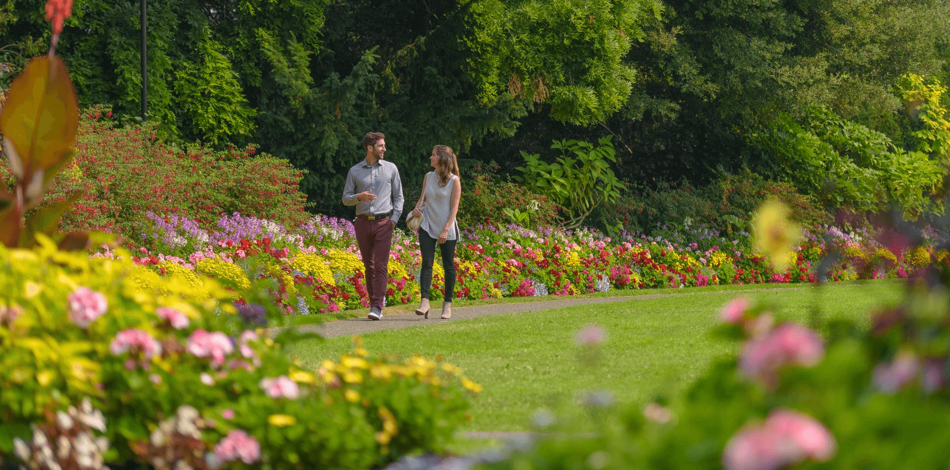 two people walking in a park