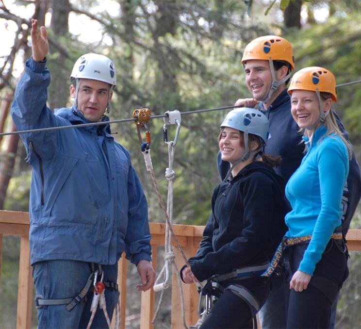 A guide and a family at the top of a zipline at Adrenaline Zipline in Victoria, BC.