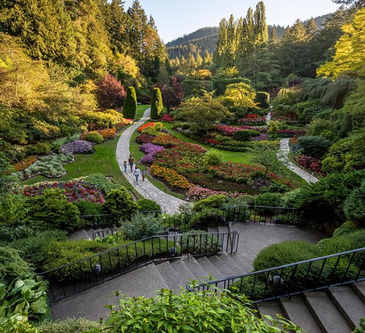 A family walks through the Sunken Garden at the Butchart Gardens in Victoria, BC