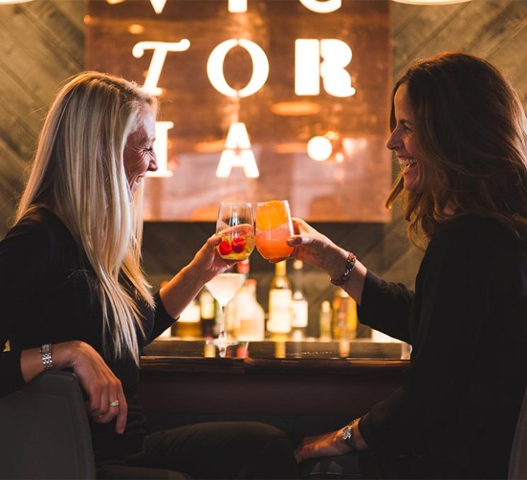 A pair of women enjoy a drink at Victoria Distillers in Victoria, BC.