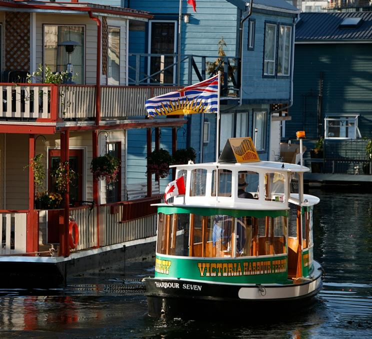 A Victoria Harbour Ferry tours Fisherman's Wharf in Victoria, BC