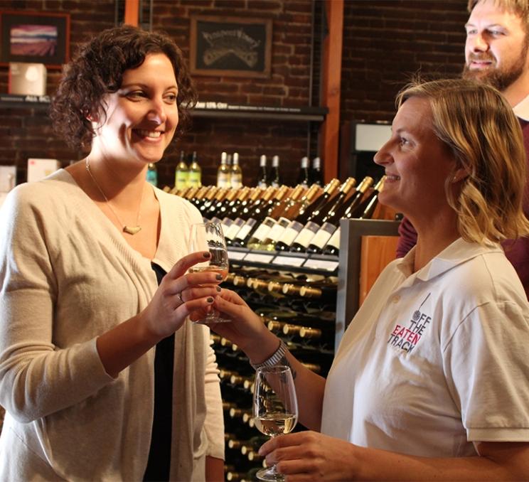 A woman enjoys some wine on an Off The Eaten Track Food Tour