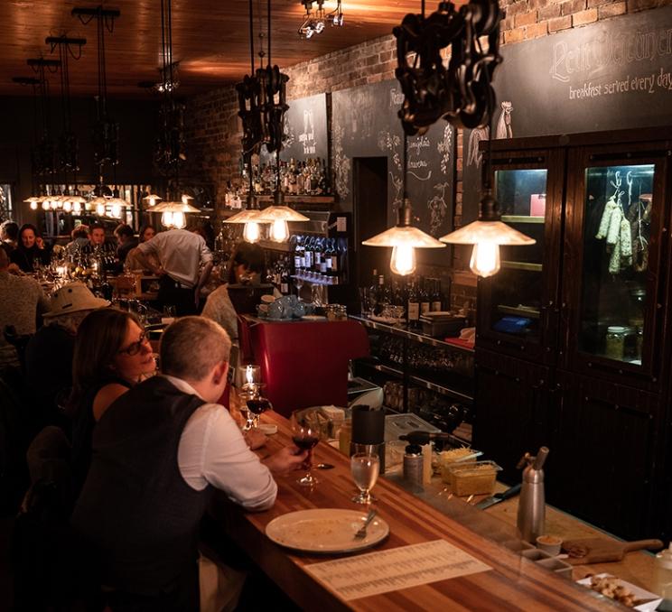 People dine inside Vis-A-Vis in Victoria, BC