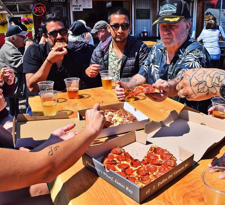 A group enjoys some pizza on a Hidden Victoria Tour