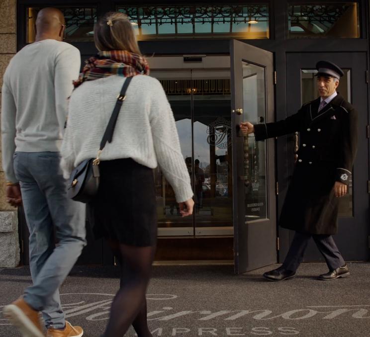 A couple is greeted by a doorman at the Fairmont Empress in Victoria, BC