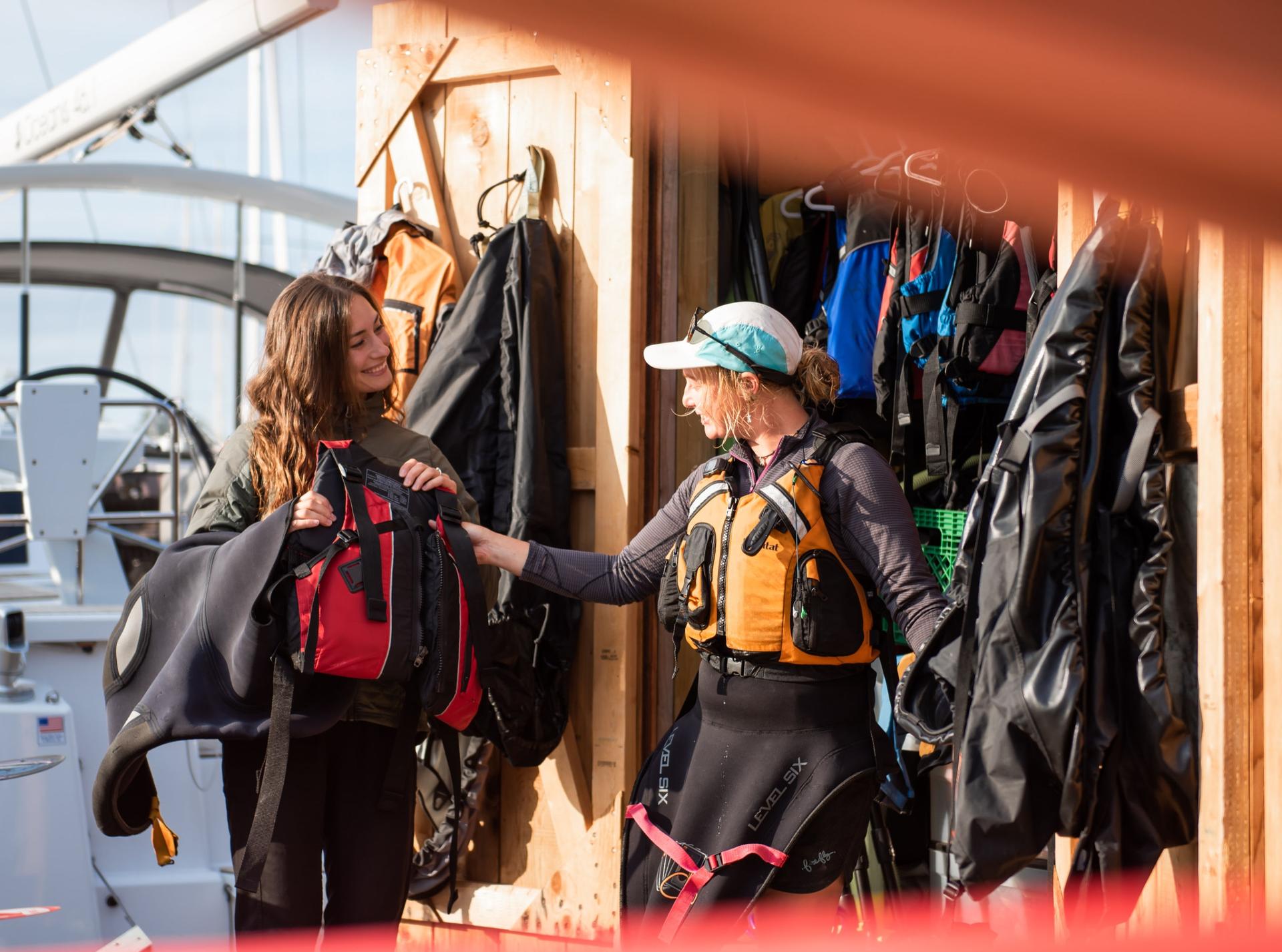 A guide prepares a guest to go kayaking in Victoria, BC