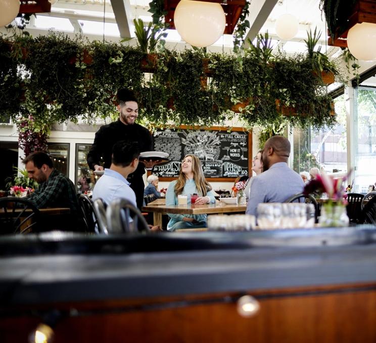 A group of delegates dines at 10 Acres Bistro in Victoria, BC