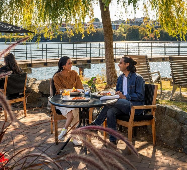 A couple dines on the patio at Glo Restaurant + Patio in Victoria, BC