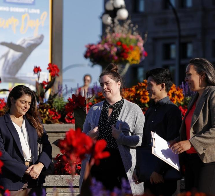 A group meets outside the Victoria Visitor Centre in Victoria, BC