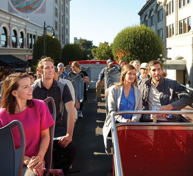 A hop-on hop-off tour bus explore downtown Victoria, BC