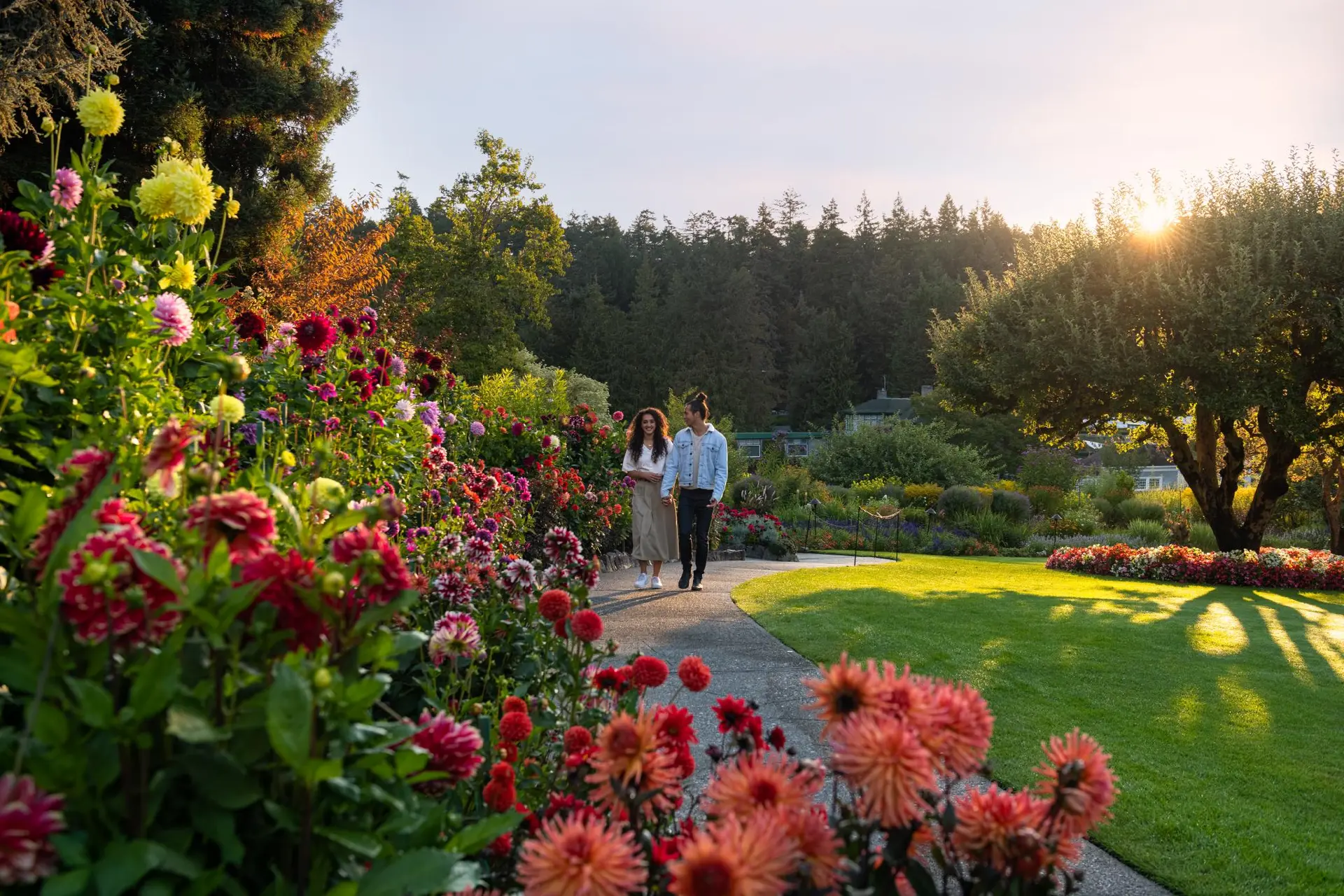 two people walking on a path in the gardens