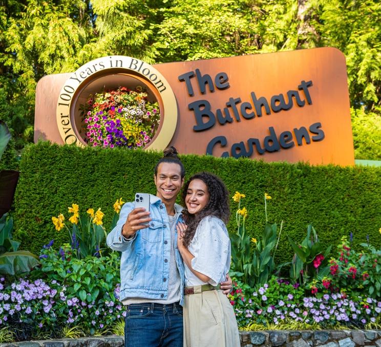 An influencer couple takes a selfie at The Butchart Gardens in Victoria, BC